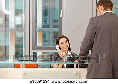 Young caucassian secretary assisting businessman View Large Photo Image Picture - Young caucassian secretary assisting businessman. Fotosearch