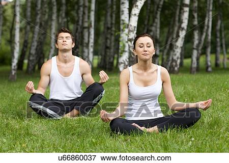 Young couple exercising in park View Large Photo Image Stock Photo - Young couple exercising in park. Fotosearch