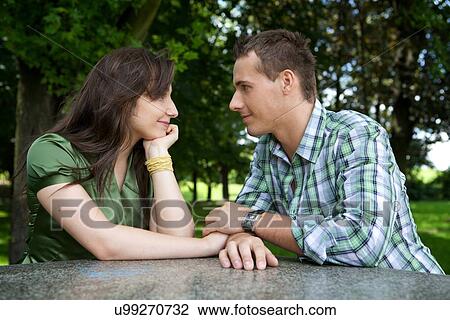 Young couple holding hands and looking at each other View Large Photo Image Stock Image - Young couple holding hands and looking at each other. Fotosearch