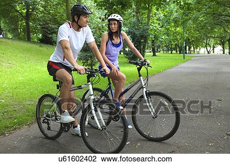 Stock Image - Young couple on bike trip. Fotosearch