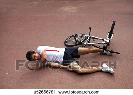 Young man injured during riding a bike View Large Photo Image Stock Image - Young man injured during riding a bike. Fotosearch
