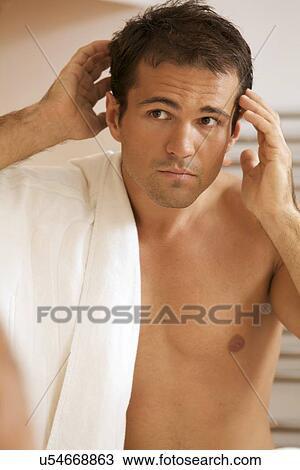 Young man looking into mirror View Large Photo Image Stock Image - Young man looking into mirror. Fotosearch