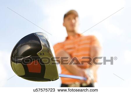 Young man playing golf, low angle view View Large Photo Image Stock Image - Young man playing golf, low angle view. Fotosearch