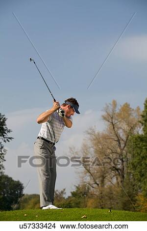 Young man playing golf View Large Photo Image Picture - Young man playing golf. Fotosearch