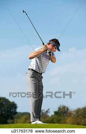 Young man playing golf View Large Photo Image Stock Photo - Young man playing golf. Fotosearch