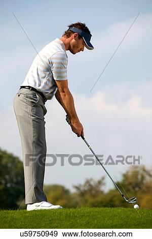 Young man playing golf View Large Photo Image Stock Photo - Young man playing golf. Fotosearch