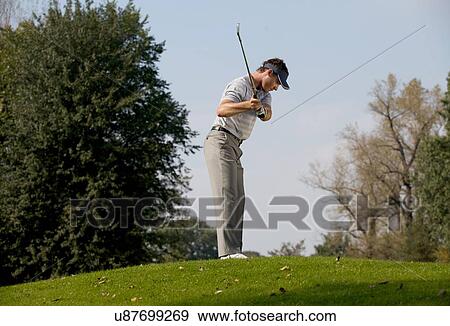 Young man playing golf View Large Photo Image Stock Photo - Young man playing golf. Fotosearch