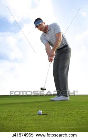 Young man playing golf View Large Photo Image Stock Photography - Young man playing golf. Fotosearch