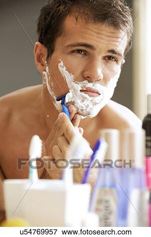 Stock Photo - Young man shaving. Fotosearch