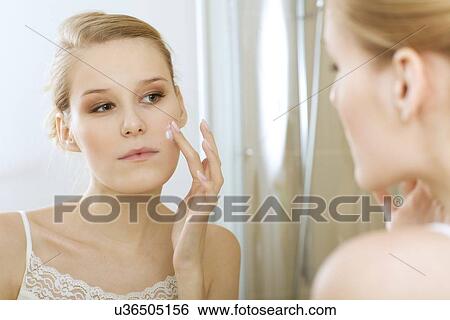 Young woman applying beauty cream, close up View Large Photo Image Stock Photograph - Young woman applying beauty cream, close up. Fotosearch