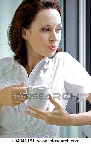 Young woman drinking coffee in the morning View Large Photo Image Stock Image - Young woman drinking coffee in the morning. Fotosearch