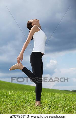 Young woman exercising in park View Large Photo Image Stock Image - Young woman exercising in park. Fotosearch