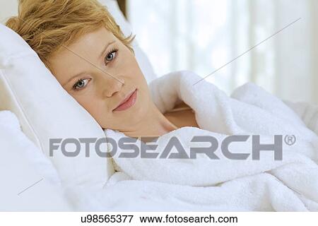 Stock Photo - young woman in bed. Fotosearch