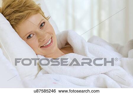 Stock Photograph - young woman in bed. Fotosearch