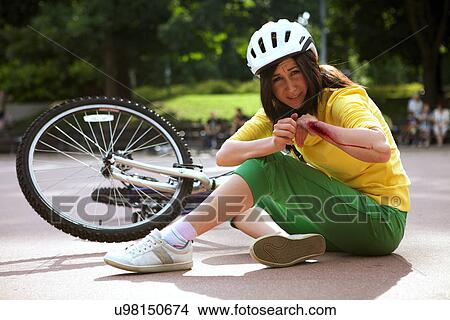Young woman injured and clutching arm View Large Photo Image Picture - Young woman injured and clutching arm. Fotosearch
