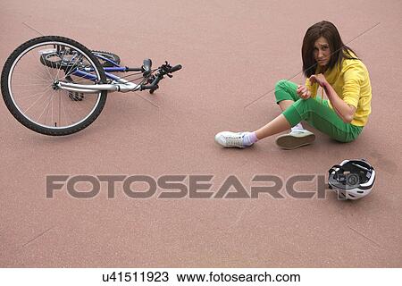 Young woman injured and clutching arm View Large Photo Image Stock Image - Young woman injured and clutching arm. Fotosearch