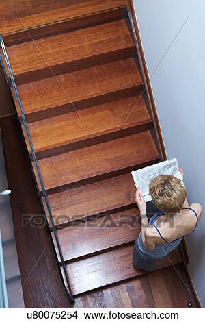 Picture - Young woman on stairs. Fotosearch