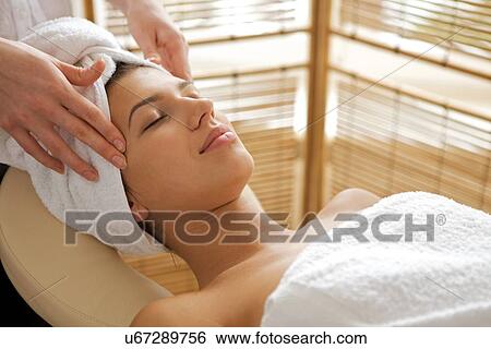 Stock Photograph - Young woman receiving energy therapy, eyes closed. Fotosearch