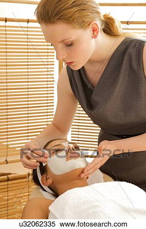 Young woman receiving facial in spa View Large Photo Image Stock Photography - Young woman receiving facial in spa. Fotosearch
