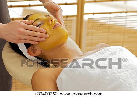 Young woman receiving facial treatment in spa View Large Photo Image Stock Image - Young woman receiving facial treatment in spa. Fotosearch