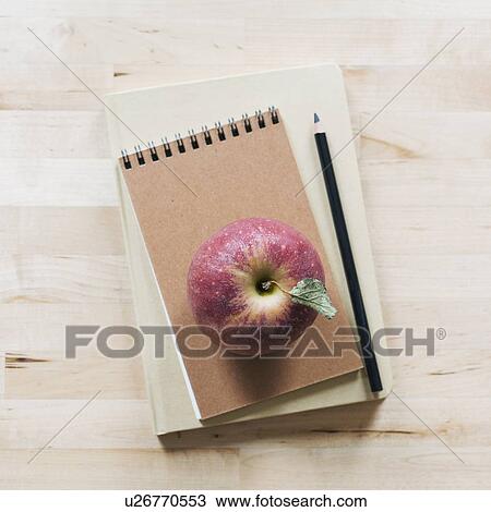 Apple on notebook View Large Photo Image Stock Image - Apple on notebook. Fotosearch