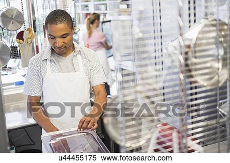 Stock Photography - Bakery owner at work. Fotosearch