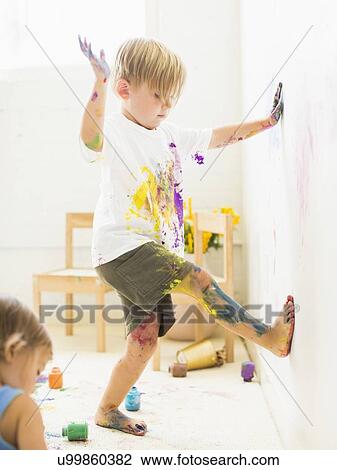 Boy (2-3) painting on wall with hands and legs View Large Photo Image Stock Image - Boy (2-3) painting on wall with hands and legs. Fotosearch