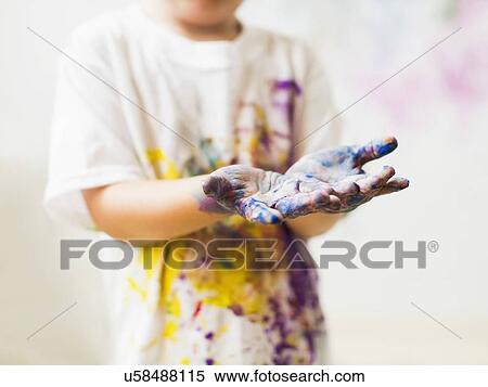 Stock Photography - Boy (2-3) showing hands in paint. Fotosearch