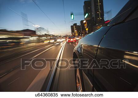 Stock Photography - Car speeding along railroad tracks. Fotosearch