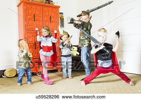 Children (2-3, 4-5, 6-7) wearing superhero costumes playing at home View Large Photo Image Stock Photograph - Children (2-3, 4-5, 6-7) wearing superhero costumes playing at home. Fotosearch