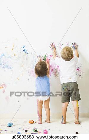 Children (2-3) painting on wall, rear view View Large Photo Image Stock Photo - Children (2-3) painting on wall, rear view. Fotosearch