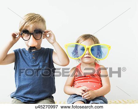 Children (2-3) wearing novelty glasses View Large Photo Image Stock Photo - Children (2-3) wearing novelty glasses. Fotosearch