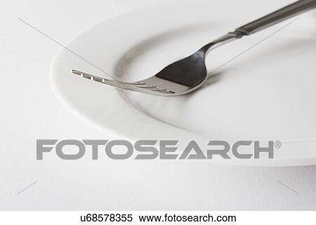 Close up of fork on plate View Large Photo Image Stock Photography - Close up of fork on plate. Fotosearch