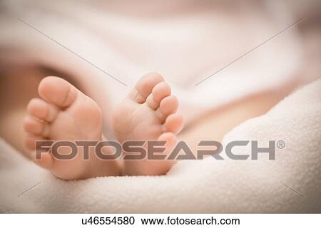 Stock Image - Close up of newborn baby (0-1 months) feet. Fotosearch