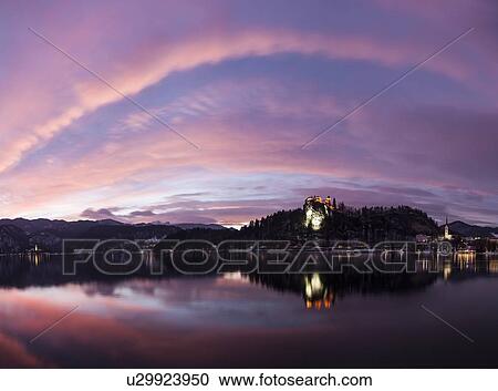 Clouds over Lake Bled and illuminated Church of the Assumption View Large Photo Image Stock Image - Clouds over Lake Bled and illuminated Church of the Assumption. Fotosearch