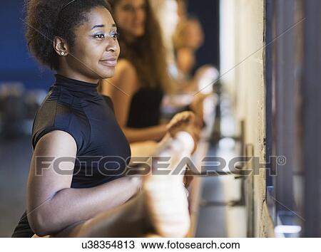 Dancers stretching in dance studio View Large Photo Image Stock Image - Dancers stretching in dance studio. Fotosearch