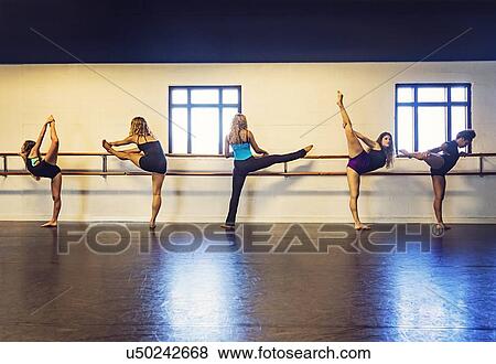 Stock Photo - Dancers stretching in dance studio. Fotosearch