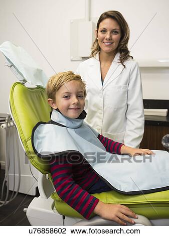 Dentist and patient (8-9) in dentist's office View Large Photo Image Stock Image - Dentist and patient (8-9) in dentist's office. Fotosearch