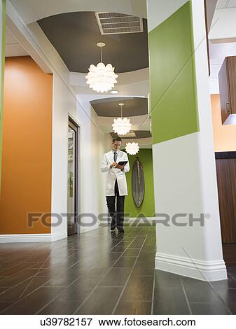 Dentist walking in corridor View Large Photo Image Stock Photo - Dentist walking in corridor. Fotosearch