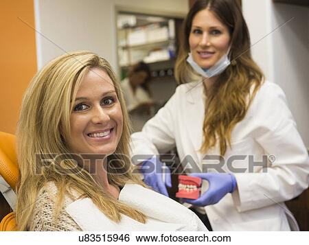 Dentists and patient in dentist's office View Large Photo Image Stock Photograph - Dentists and patient in dentist's office. Fotosearch