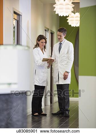 Dentists talking in corridor View Large Photo Image Stock Image - Dentists talking in corridor. Fotosearch