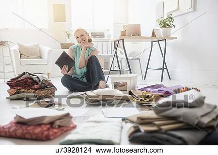 Design professional working in living room View Large Photo Image Picture - Design professional working in living room. Fotosearch