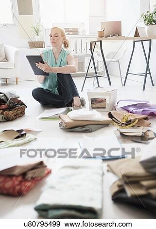 Stock Photo - Fashion designer working in studio. Fotosearch