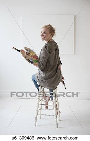 Female artist painting in studio View Large Photo Image Stock Photograph - Female artist painting in studio. Fotosearch