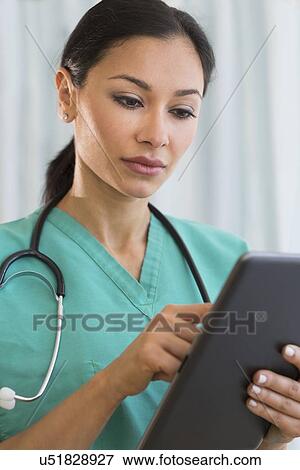 Female doctor using digital tablet View Large Photo Image Stock Photo - Female doctor using digital tablet. Fotosearch