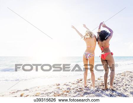 Female friends dancing on beach View Large Photo Image Stock Photograph - Female friends dancing on beach. Fotosearch