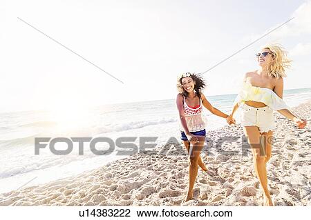 Female friends on beach View Large Photo Image Stock Image - Female friends on beach . Fotosearch