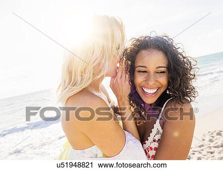 Stock Image - Female friends on beach. Fotosearch