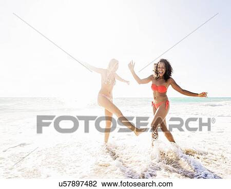 Female friends on beach View Large Photo Image Stock Image - Female friends on beach . Fotosearch