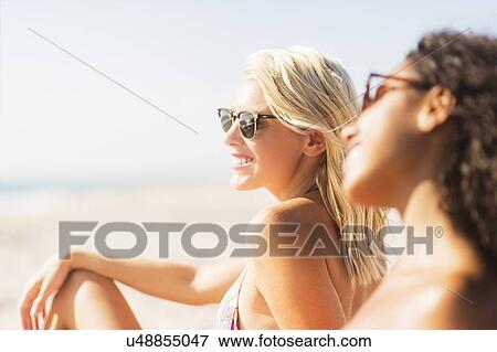 Stock Photo - Female friends on beach . Fotosearch
